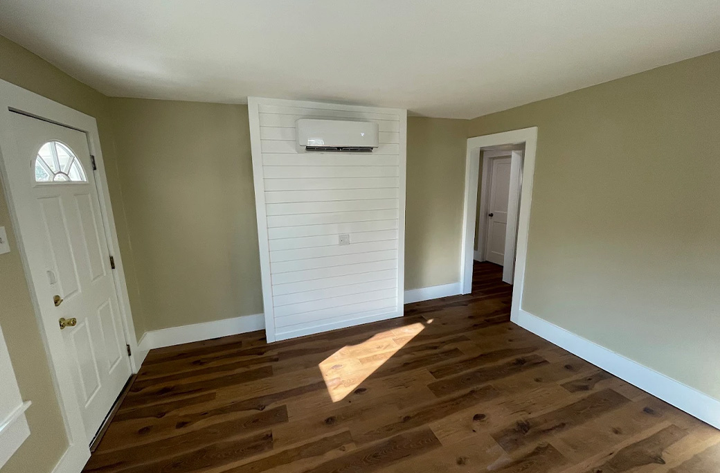 Freshly painted white trim and door frame beside a finished wall